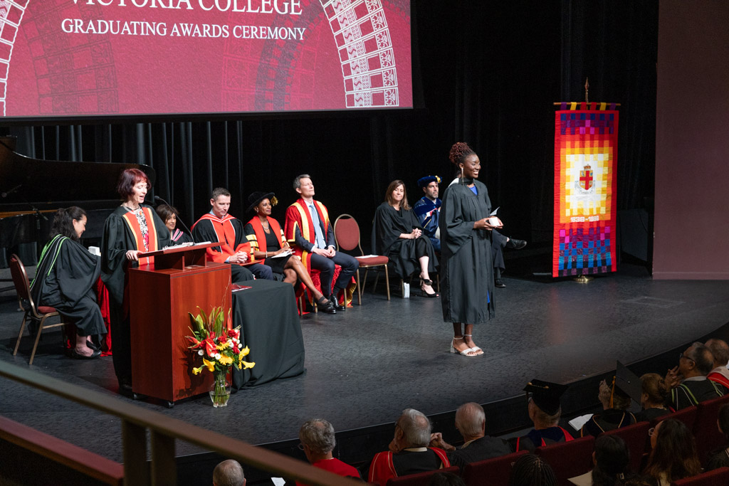 A students stands on stage during the 2024 Victoria College Graduating Awards ceremonies.