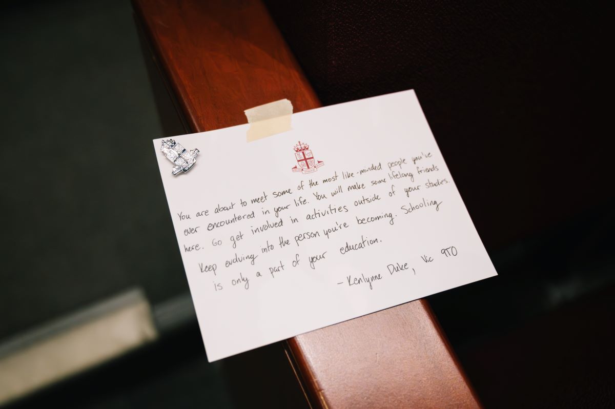 A white card with a heartfelt hand-written message is taped to a seat armrest.