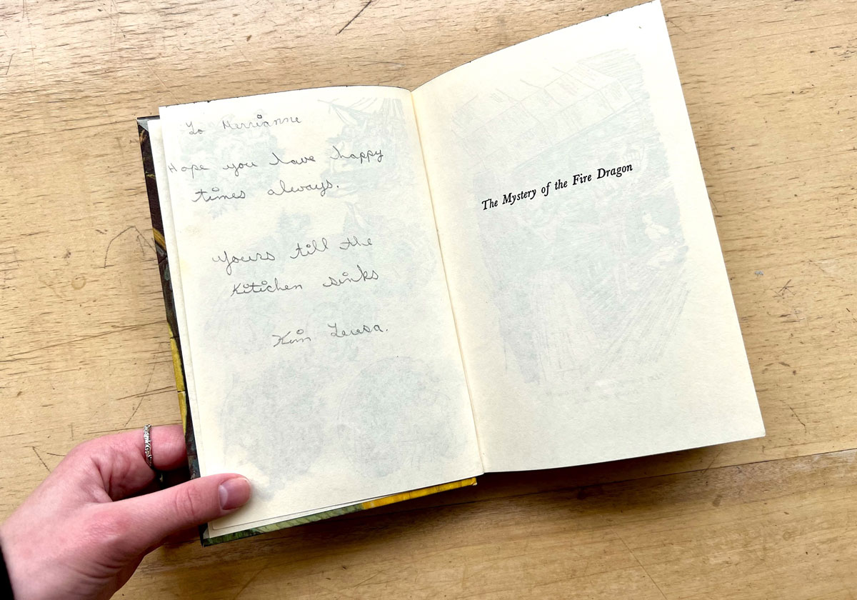 Doiny’s copy of The Mystery of the Fire Dragon, the 38th book in the series, features a handwritten note in its early pages. 